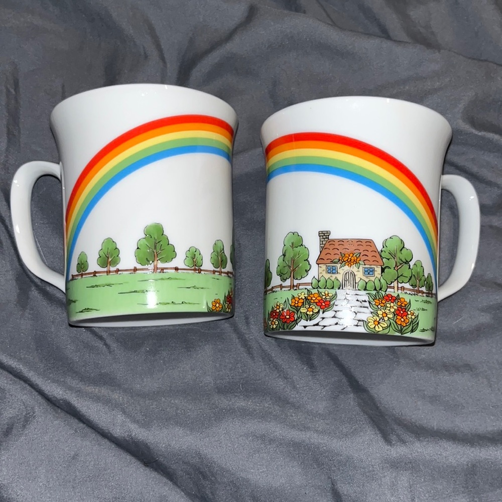 Set of two tea cups rainbow over cottage